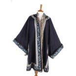 A Chinese midnight blue winter robe, with deep sleeve bands embroidered with colourful silks showing