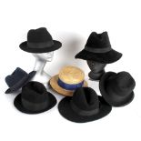 A collection of thirteen hats, including: a black felt fedora; a New Putney trilby; a 1945 de-mob