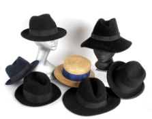 A collection of thirteen hats, including: a black felt fedora; a New Putney trilby; a 1945 de-mob