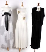 A quantity of evening dresses, comprising: a D.P. Gowns of London black evening dress with a