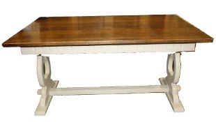 An oak refectory table with a painted trestle base, used for shop display.