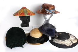 A natural and black straw hat by Derry and Toms; an early 20th century brown straw hat; a 1930s