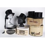Four black silk top hats with card boxes, three of the hats have a circumference of 21.5in, the