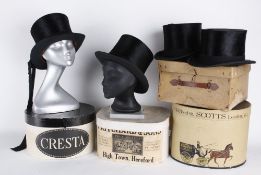 Four black silk top hats with card boxes, three of the hats have a circumference of 21.5in, the