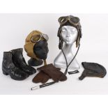 A leather flying helmet with two pairs of flying goggles and a badge; together with a black