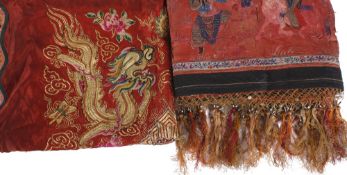 A Chinese red silk pelmet, embroidered with figures (some damage, colour bleed and loose threads); a