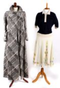 A 1970s grey, black and white maxi coat with matching skirt; a cream wool dress with a floral design