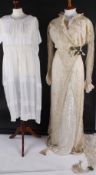 An early 20th century cream silk and lace wedding dress; together with a black velvet 19th century