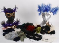 A mixed lot of Venetian style feather masks; together with a quantity of feather trimmings;