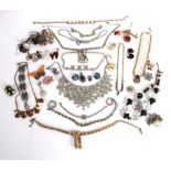 A quantity of vintage costume jewellery, including: diamante and paste necklaces, clip-on
