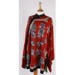 An early 20th century Chinese red silk jacket, embroidered with flowers worked in shades of blue and