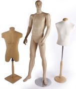 A composition male mannequin with detachable limbs on a metal stand; together with a clear plastic