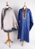 An early 20th century Chinese red silk robe, embroidered with blue, white and gold silks, blue