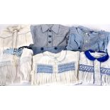 A collection of mid 20th century boys clothing, including: romper suits, cotton striped shorts,