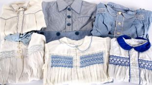 A collection of mid 20th century boys clothing, including: romper suits, cotton striped shorts,