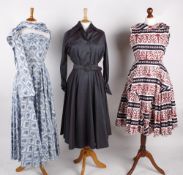 A 1950s black, white and red cotton summer dress, with frilled hem and bow details to the collar;