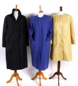 A blue wool coat by Weill of Paris; a Harrods raincoat; a yellow Dannimac coat; and a brown