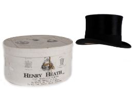 A black silk top hat by Henry Heath, in the original box dated 1936, 57cm circumference.