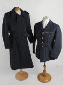 An RAF Officer's day and dress uniforms, circa 1950s; together with two raincoats, an RAF cap, a