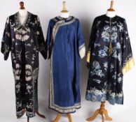 An early 20th century Chinese midnight blue silk robe, satin stitch embroidered roundels designed