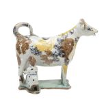 An English pearlware Pratt-type cow-creamer with attendant milk-maid  An English pearlware Pratt-