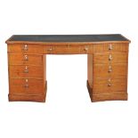 A Victorian satinwood serpentine fronted desk, circa 1890  A Victorian satinwood serpentine