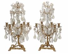 A pair of French moulded and cut glass and gilt metal mounted six light... A pair of French