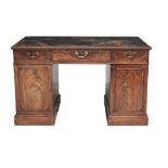 A George III mahogany desk, circa 1780, the rectangular top with a leather...  A George III mahogany