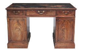 A George III mahogany desk, circa 1780, the rectangular top with a leather...  A George III mahogany