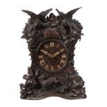 A rare Black Forest carved wood quarter-striking cuckoo table clock...  A rare Black Forest carved