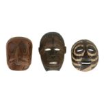 Three African tribal masks, of varying design, 63, 40 and 39cm high respectively 30, 35 and 31cm