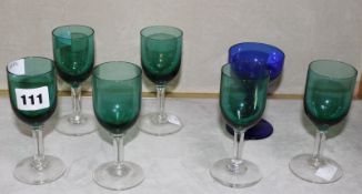 A set of six green glass drinking glasses on clear stems and a blue glass drinking glass -7