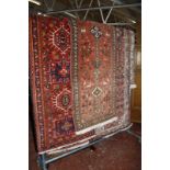 A collection of seven Middle Eastern hand made rugs and a part machine made rug. -8