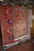 A collection of seven Middle Eastern hand made rugs and a part machine made rug. -8