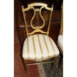 A gilt salon chair with lyre shaped back.