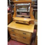 A Victorian satin walnut dressing chest the swing mirror above trinket drawer and base with three