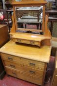 A Victorian satin walnut dressing chest the swing mirror above trinket drawer and base with three