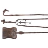 A set of three wrought iron fire irons in Arts and Crafts style, circa 1900, comprising shovel,