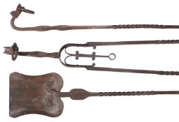 A set of three wrought iron fire irons in Arts and Crafts style, circa 1900, comprising shovel,
