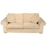 A cream two seat sofa, 20th century, with removable cushions, scroll arms and block feet 80cm