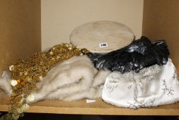 A quantity of vintage clothing and accessories to include a red long evening coat, a vintage fur