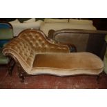 A Victorian chaise longue with a mahogany swept show frame raised on cabriole supports