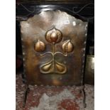 An Art Nouveau copper and iron fireguard, a brass coal bin, a pair of andirons, bellows and other