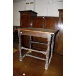 A 17th century style oak table with ring turned legs and stretcher