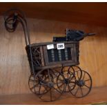 A Victorian style toy pram.Best Bid