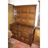 A 19th Century style oak dresser with a plate rack over a base of drawers and cupboards.