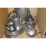 A quantity of pewter items to include assorted teapots, a circular tray and silver plated trays Best