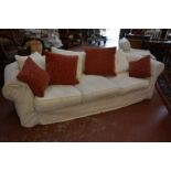 A cream three seater sofa 257cm length Best Bid