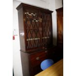 A Regency mahogany and inlaid secretaire bookcase, with glazed upper section and secretaire drawer