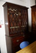 A Regency mahogany and inlaid secretaire bookcase, with glazed upper section and secretaire drawer